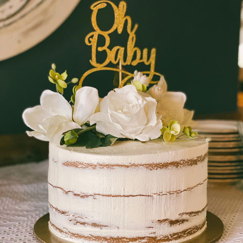 white and golden cake with flowers