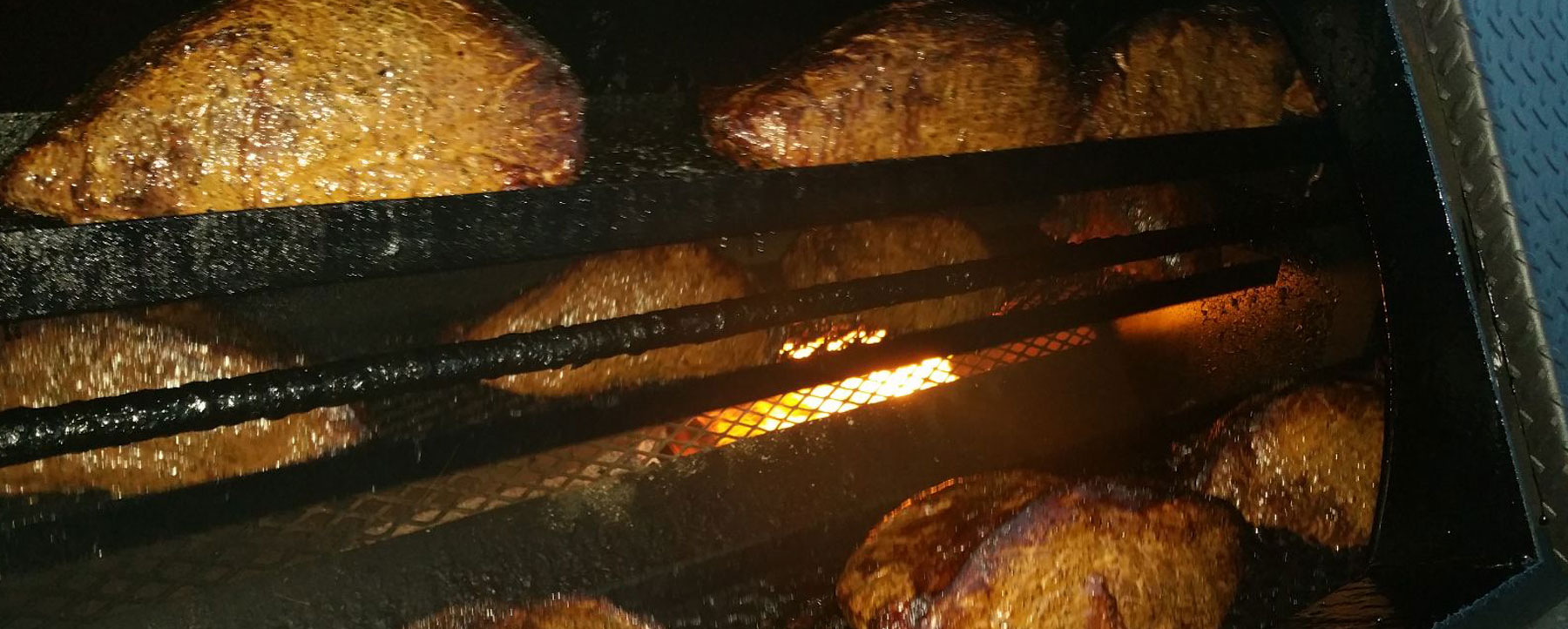 meats rotating in bbq smoker